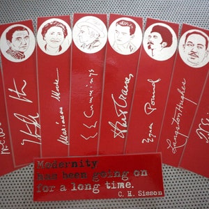 May include: A set of red bookmarks featuring portraits of notable figures and their signatures in silver. The bookmarks include the text "Modernity has been going on for a long time. C. H. Sisson."