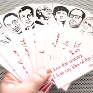 May include: A set of eight black and white bookmark illustrations of famous Canadian musicians. The bookmarks are printed on white paper with red text. The text on the bottom bookmark reads "I love this country. I love my idea of this country. - Gord Downie".