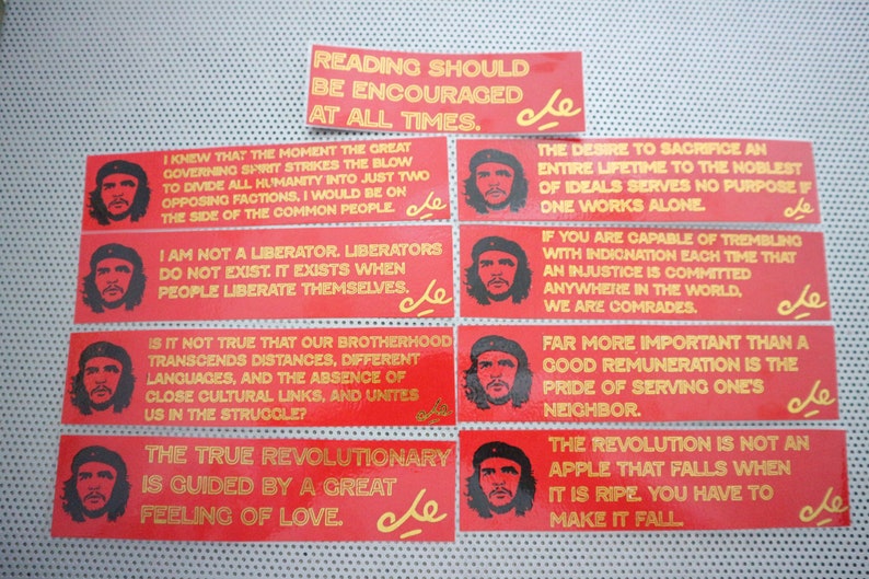 May include: Ten red rectangular stickers with yellow text and a small red star with the letters "che" in yellow. The text on the stickers includes quotes from Che Guevara, such as "Reading should be encouraged at all times." and "The true revolutionary is guided by a great feeling of love."