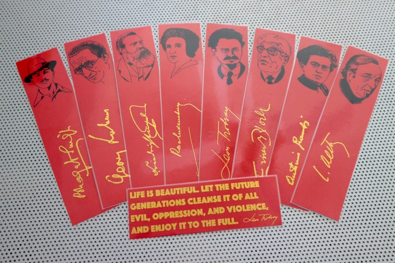 May include: Set of ten red bookmarks with black and white illustrations of famous people. Each bookmark has a gold signature and a quote in gold lettering: "LIFE IS BEAUTIFUL LET THE FUTURE GENERATIONS CLEANSE IT OF ALL EVIL, OPPRESSION, AND VIOLENCE, AND ENJOY IT TO THE FULL. Len Trotsky"