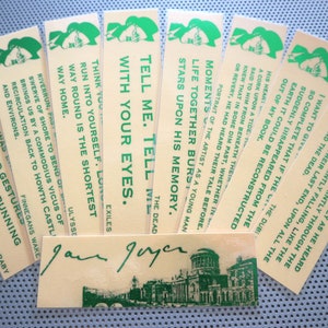 May include: A set of ten bookmarks featuring a green illustration of a woman's head with a hat. Each bookmark has a different quote from the book Ulysses by James Joyce. The bookmarks are printed on a cream-colored background. The signature of James Joyce is printed on one of the bookmarks.