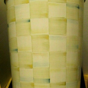 May include: A white metal trash can with a gold rim and a yellow and blue checkered pattern.