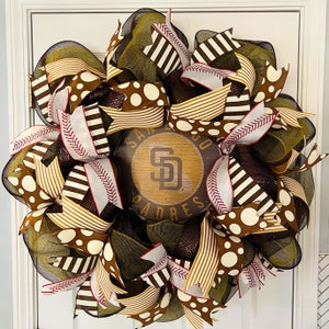 May include: A brown, white, and black San Diego Padres wreath with a wooden sign that says "San Diego Padres".