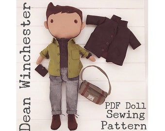 May include: A PDF sewing pattern for a doll, featuring a doll dressed in a green shirt, grey jeans, a brown jacket, and a brown bag. The doll has brown hair and brown eyes. The text "Dean Winchester" is written vertically on the left side of the image. The text "PDF Doll Sewing Pattern" is written in the bottom right corner of the image.