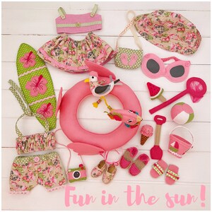 May include: A collection of pink and green felt toys for children, including a swimsuit, a beach bag, a sun hat, a pair of sunglasses, a beach ball, a beach towel, a pair of flip flops, a camera, a seagull, a watermelon, a bucket and shovel, and a life preserver. The toys are arranged on a white wooden surface. The text "Fun in the sun!" is written in pink letters at the bottom of the image.
