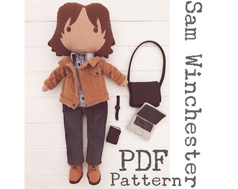 May include: A PDF pattern for a plush doll of Sam Winchester from the TV show Supernatural. The doll is wearing a brown jacket, blue jeans, and a checked shirt. The pattern includes instructions for making the doll's clothes and accessories, such as a laptop, a book, and a watch.