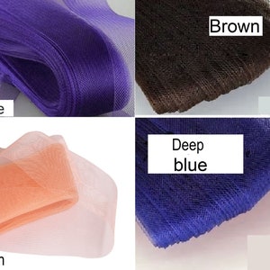 May include: Four rolls of tulle fabric in different colors: purple, brown, peach, and deep blue. The fabric is soft and sheer, and it is perfect for crafting and decorating.