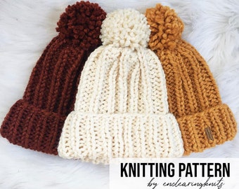 May include: Three knitted hats with pom-poms in brown, white, and yellow. The hats are stacked on top of each other. The text "Knitting Pattern by enclearingknits" is at the bottom of the image.