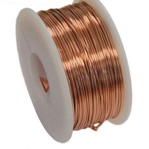 May include: A spool of copper wire, wound tightly on a white plastic spool. The wire is a warm copper color.