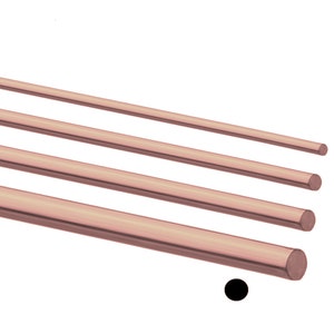 May include: Four different sizes of rose gold colored metal rods. The rods are arranged in a diagonal line from top left to bottom right. The rods are all round in shape and have a smooth finish.