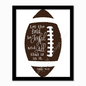 Puede incluir: Un balón de fútbol marrón con costuras blancas y el texto "Let the field be Joyful and All that is in it. Psalm 96:12" impreso en él.