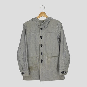 May include: A blue and white striped jacket with a hood, four black buttons, and two front pockets. The jacket is hanging on a wooden hanger.