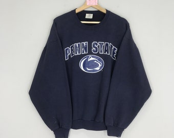 May include: A navy blue sweatshirt with the words "Penn State" and a blue and white Nittany Lion logo on the front.