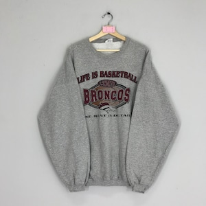 May include: Grey sweatshirt with a graphic print of a basketball and the text "Life is Basketball 49 North Broncos The Rest is Detail".