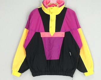May include: A black, pink, yellow and neon pink colour block windbreaker jacket with a snap button closure and a drawstring at the waist. The jacket has a small black patch with the text "SPORT 13" on the left side.