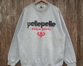 May include: Gray sweatshirt with a black and red "pellepelle denim goods" logo and a red and black logo of a stylized arm with a barbell.