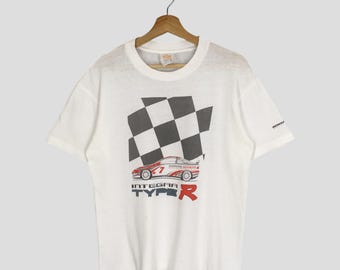 May include: White t-shirt with a racing car graphic and a chequered flag design. The text "INTEGRA TYPE R" is displayed prominently, with the Honda logo on the sleeve.
