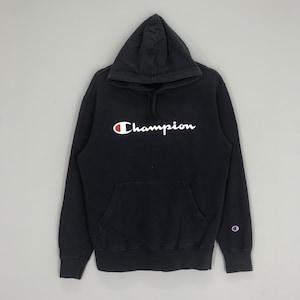 May include: Black Champion hoodie with a white logo on the front and a small Champion logo on the left sleeve.