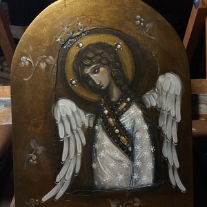 May include: A painting of an angel with white wings and a gold halo. The angel is wearing a white dress with gold accents and is holding a golden staff. The background is a gold and brown color.