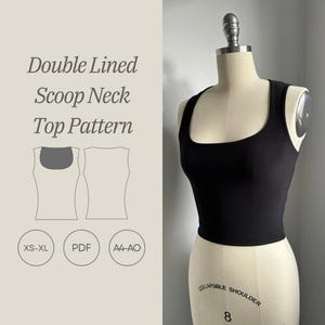 May include: A black scoop neck top pattern with a double lined design. The pattern is available in sizes XS-XL and is printed on A4-AO paper. The pattern is available as a PDF download.