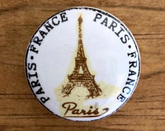 White ceramic Paris France decal furniture / cabinet knob with black lettering and sepia Eiffel Tower detail
