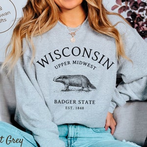 May include: A rustic wooden sign with the text "Welcome to our home" in white lettering. The sign features a distressed finish and a simple, inviting design, perfect for entryway decor.