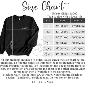 May include: Size chart for a unisex Gildan 18000 sweatshirt. The chart shows the chest and length measurements in inches and centimeters for sizes S, M, L, XL, 2XL, and 3XL. The text states that the fit is true to size with a looser fit.