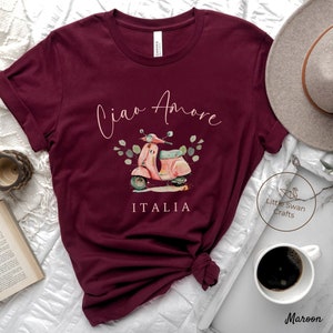 May include: Maroon t-shirt with a pink scooter graphic and the text "Ciao Amore ITALIA".
