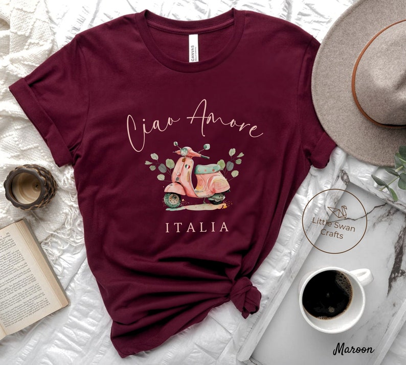 May include: Maroon t-shirt with a pink scooter graphic and the text "Ciao Amore ITALIA".