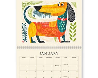 May include: A wall calendar for January featuring a stylised illustration of a dachshund with a yellow head, orange body, and black ears. The dog wears a red collar with a white buckle. The calendar grid includes dates and text for January.