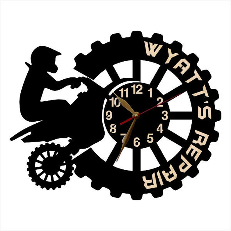 May include: Black and white silhouette of a dirt bike with a clock face in the center. The clock face has black numbers and hands. The words "Wyatt's Repair" are written around the outside of the clock face.