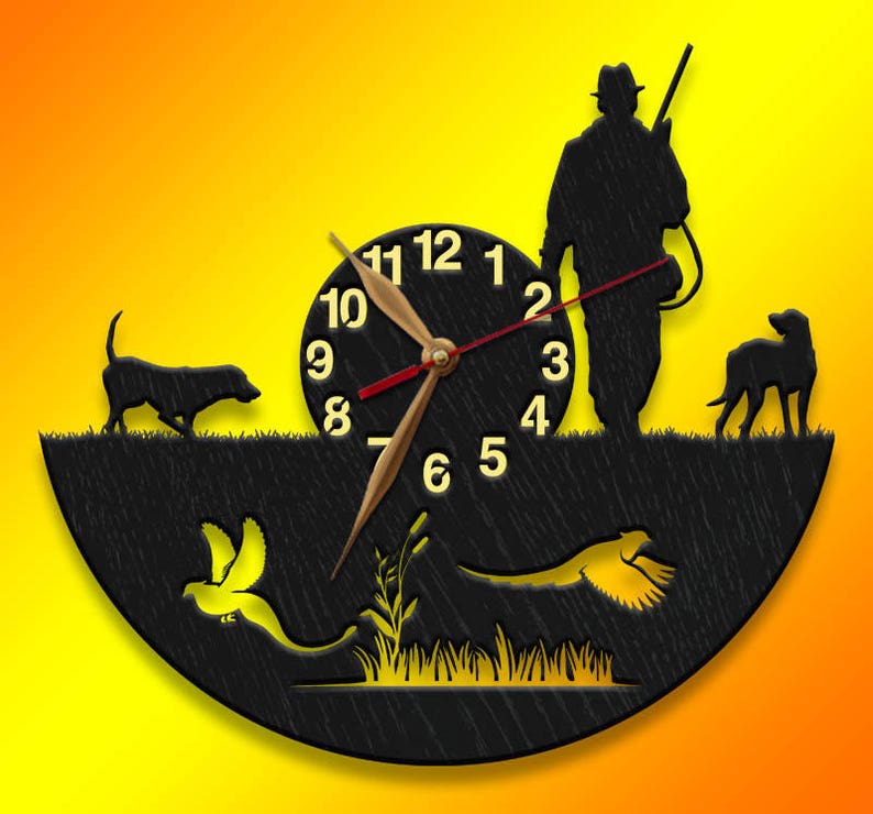 May include: A black wooden clock with a hunter, two dogs, and two birds in silhouette. The clock face has Roman numerals and a red second hand.