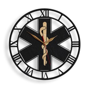 May include: Black and white wall clock with Roman numerals and a black star of life with a snake and staff symbol in the center.