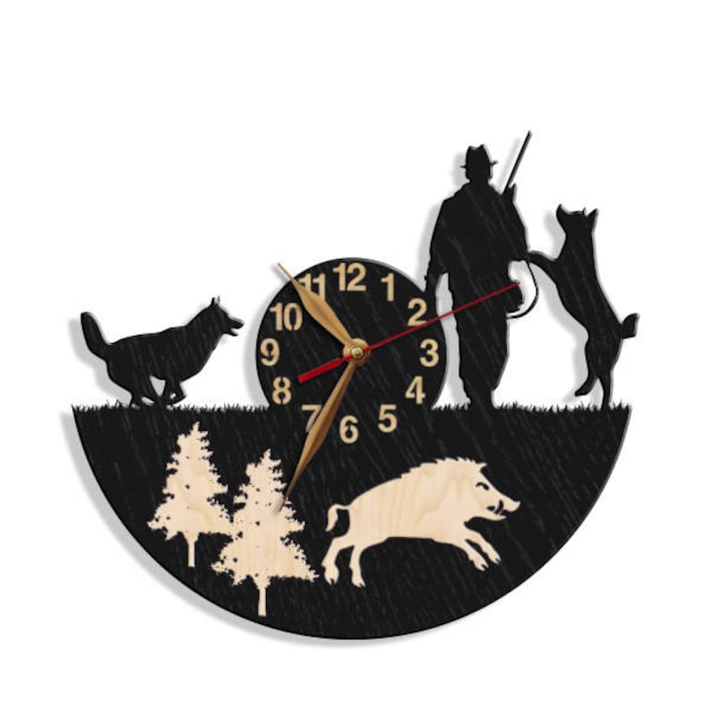 May include: Black and white silhouette wall clock with a hunter, two dogs, a wild boar, and trees. The clock face has Roman numerals and a gold-colored hour hand and minute hand.