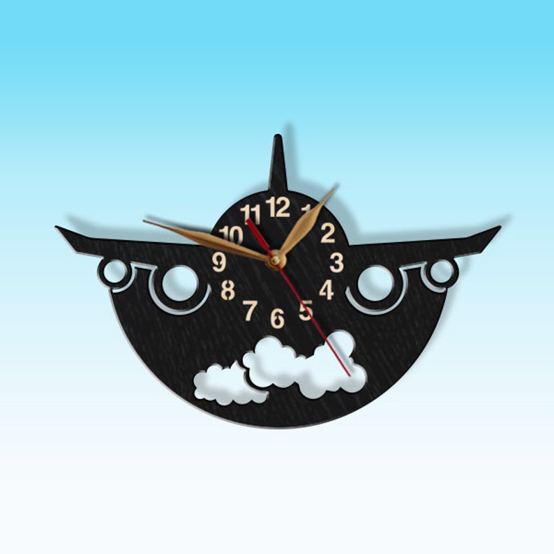 May include: Black wooden aeroplane wall clock with gold hands and white clouds. The clock face has numbers 1-12.