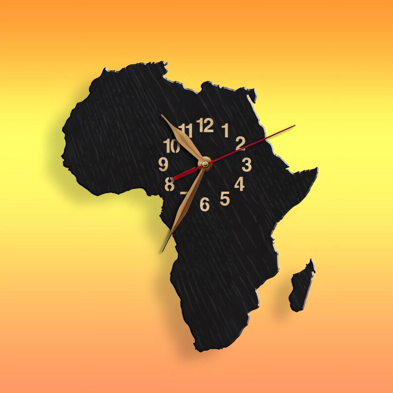 May include: A black wall clock shaped like the African continent. The clock has gold-colored hands and numerals, with a red second hand. The background is a gradient of yellow and orange.