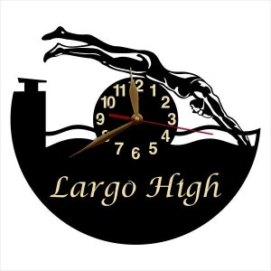 May include: Black vinyl record clock with a silhouette of a swimmer diving into water. The clock face has gold numbers and a brown hand. The text "Largo High" is printed below the clock face.