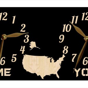 May include: A black wooden clock with two clock faces, each with a map of the United States in the centre. The clock faces are labelled "ME" and "YOU".