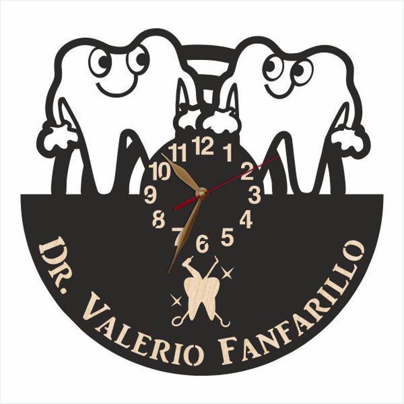 May include: Black and white clock with a dentist theme. The clock face features two cartoon teeth with smiling faces. The clock hands are red and gold. The clock is surrounded by a black circle with the text "Dr. Valerio Fanfarillo" in white.