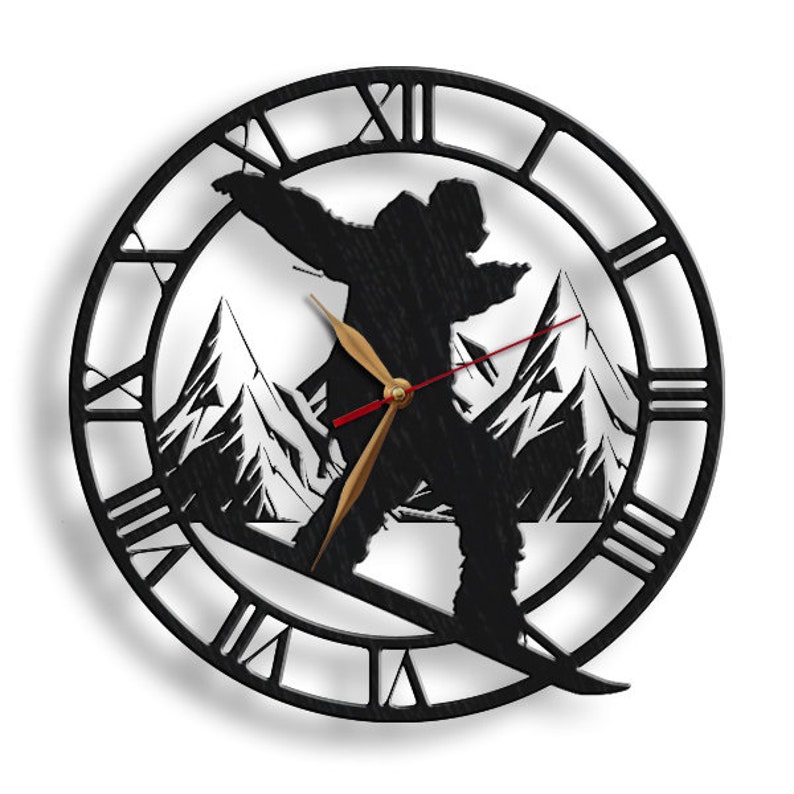 May include: Black and white wall clock with a silhouette of a person snowboarding down a mountain. The clock face has Roman numerals.