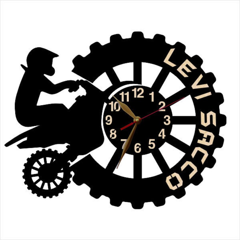 May include: Black and white silhouette of a person riding a dirt bike with a clock face in the background. The clock face has black hands and a black rim with white numbers. The text "Levi Saco" is written around the clock face.