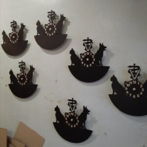 May include: Five black vinyl record clocks with a veterinarian symbol and silhouettes of a cat and dog. The clocks have white numbers and hands.
