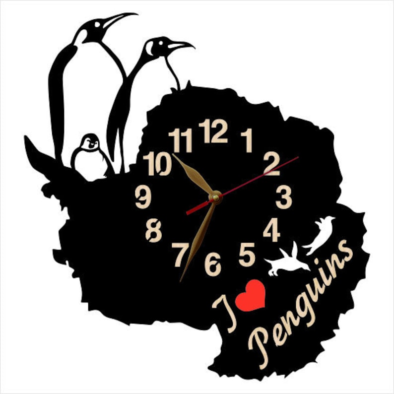 May include: Black and white clock shaped like the continent of Antarctica with penguins and the text "I love penguins". The clock face has gold numbers and hands.