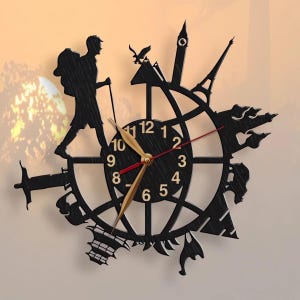 May include: Black clock with gold hands and Roman numeral markings. The clock is surrounded by silhouettes of landmarks from around the world, including the Eiffel Tower, the Statue of Liberty, and the Great Wall of China.