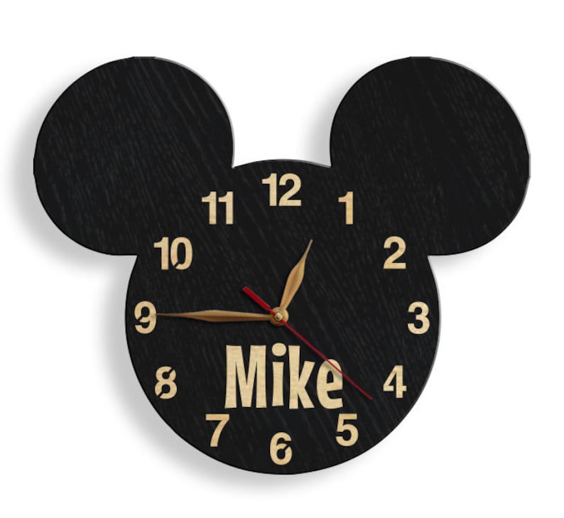 May include: Black wooden Mickey Mouse-shaped clock with gold numbers and hands. The clock face also has the name "Mike" written in gold letters.