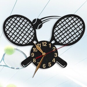 May include: A black wooden clock with a tennis racket design. The clock face is black with white numbers and gold hands. A tennis ball is depicted in the design, being hit by a racket.