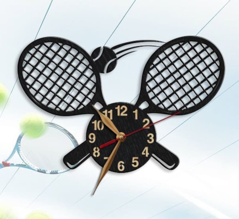 May include: A black wooden clock with a tennis racket design. The clock face is black with white numbers and gold hands. A tennis ball is depicted in the design, being hit by a racket.