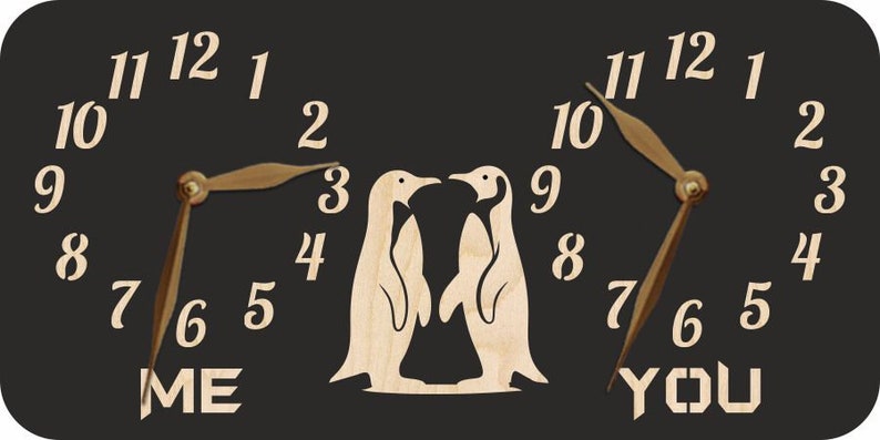 May include: A black wooden clock with two penguin silhouettes in the centre. The clock faces read "ME" and "YOU" with the numbers 1 through 12 around each clock face.