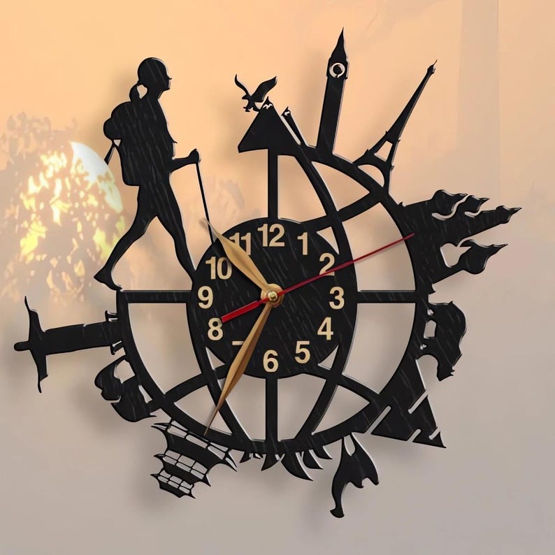 May include: Black clock with a silhouette of a person walking with a backpack and hiking poles. The clock face has gold numbers and hands, and the clock is surrounded by silhouettes of famous landmarks from around the world.