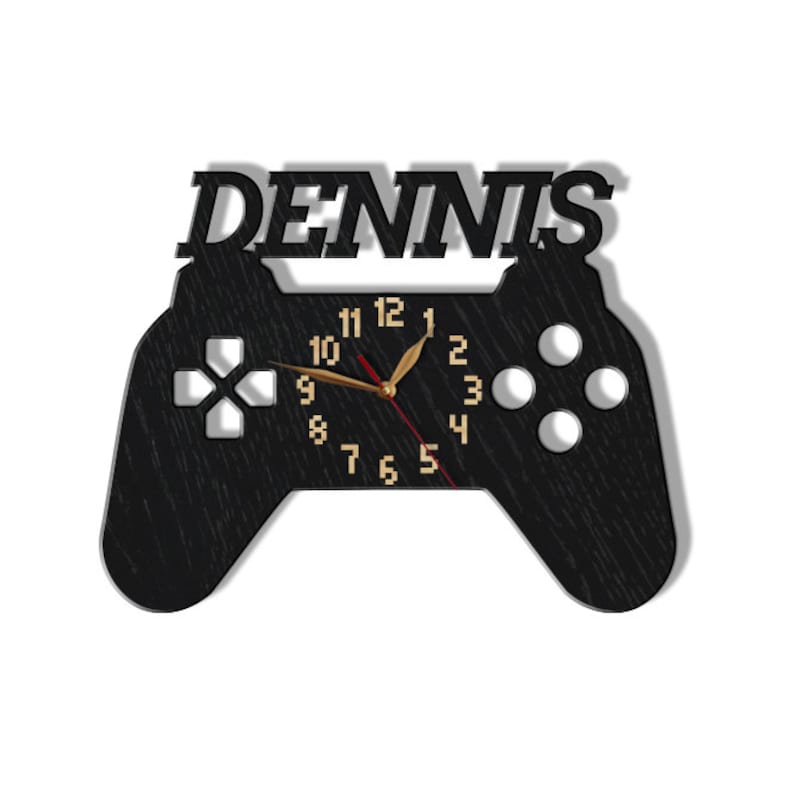May include: Black wooden game controller clock with the name "DENNIS" above the clock face. The clock face has gold numbers and hands.